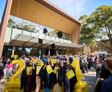 Students and their families celebrate graduations outside the Clancy Auditorium